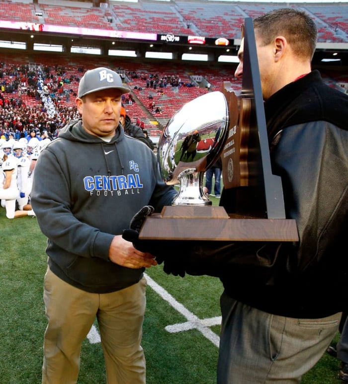 Brookfield (WIs.) Central High School football coach Jed Kennedy accepts the 2018 WIAA Division 2 runner-up trophy following the team's 51-14 loss to Homestead in Madison on Nov. 16.